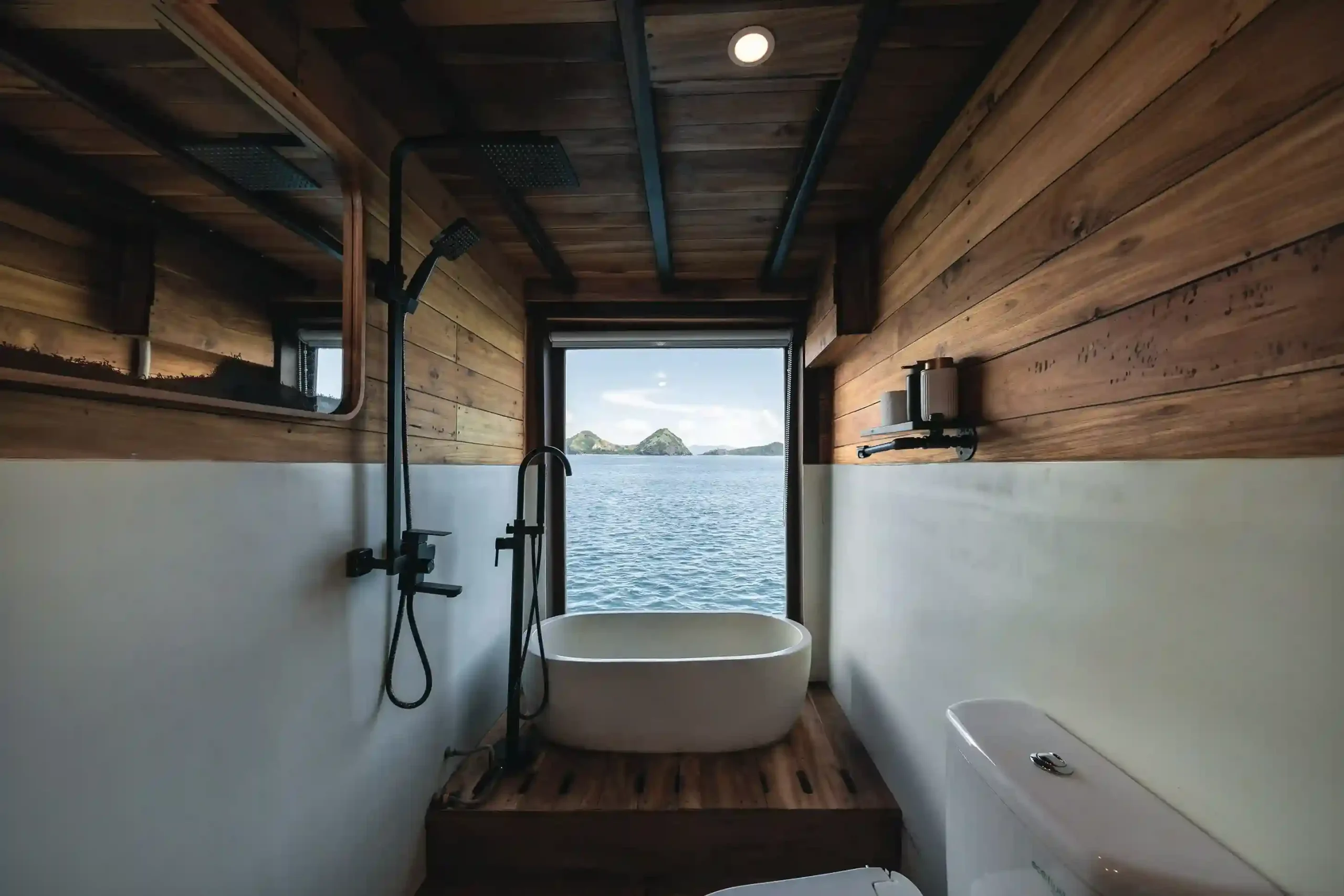 Mentawai cabin bed and portholes on Elbark Cruise